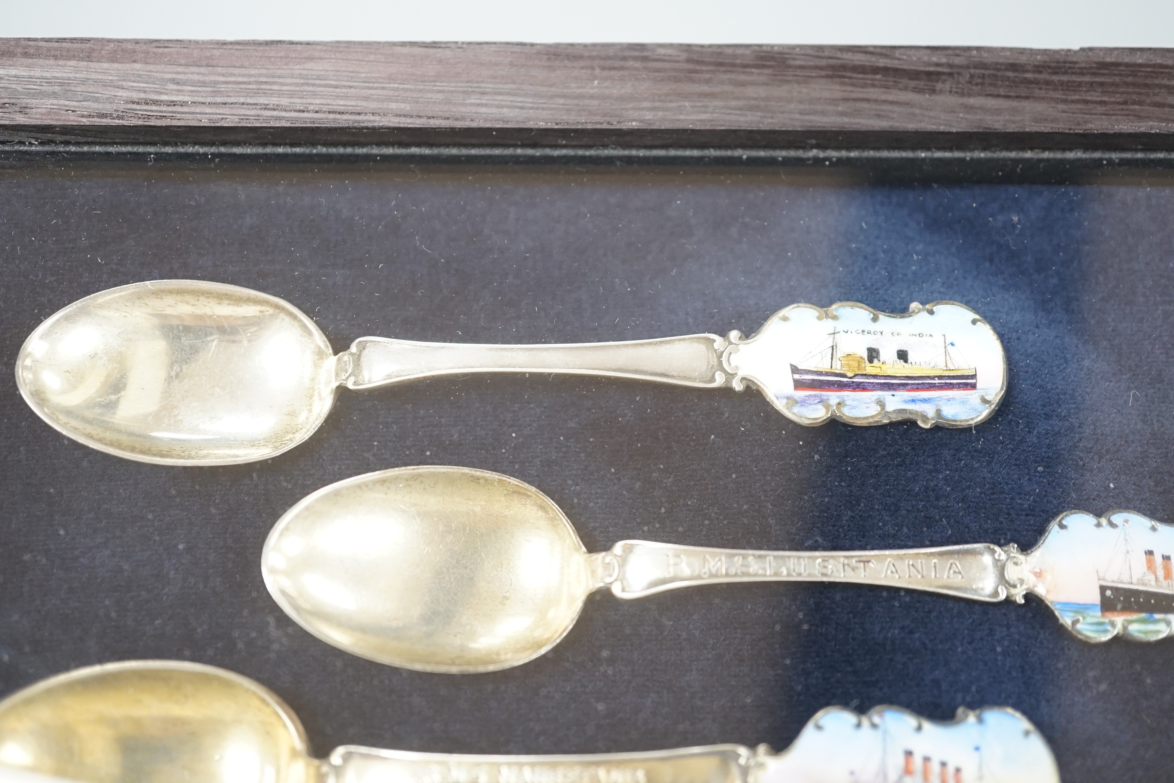 Cunard and P&O liners interest - four early 20th century silver and enamel souvenir spoons, inscribed RMS Lusitania, RMS Aquitania, RMS Mauretania and Viceroy of India, cased